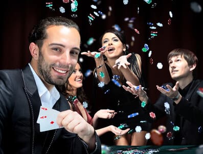 Poker players sitting around a table at a casino